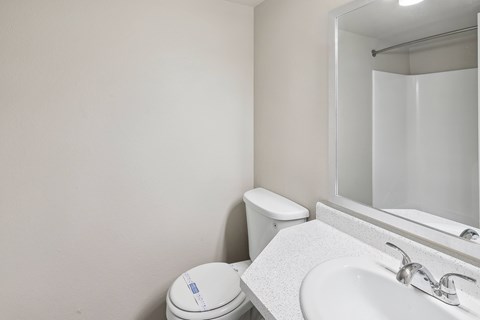 a bathroom with a sink toilet and a mirror